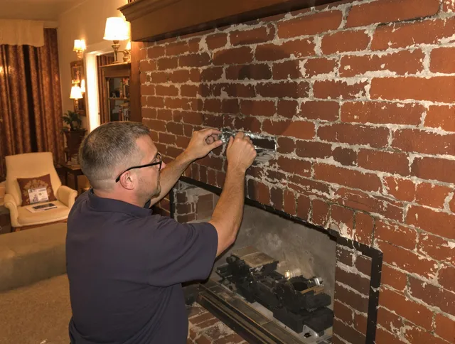 North Ridgeville Chimney Sweep expert fixing a fireplace in North Ridgeville, OH